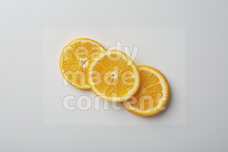 Three orange slices on a white background
