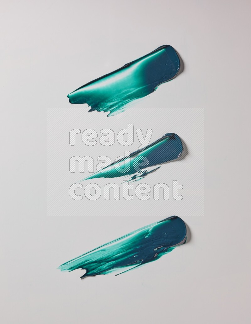 Turquoise painting knife strokes on white background