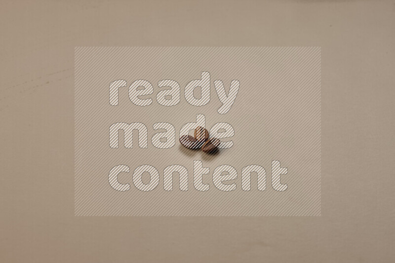 Roasted coffee beans on beige background