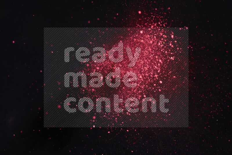 Red powder explosion on black background