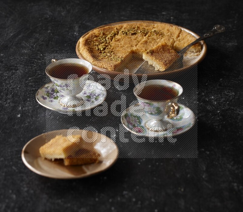 konafa with tea in a dark setup