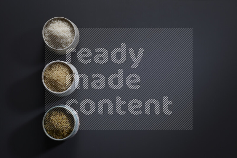 Legumes in pottery bowls on grey background