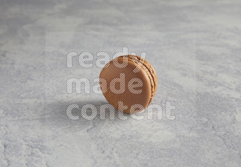 45º Shot of Brown Coffee macaron on white  marble background
