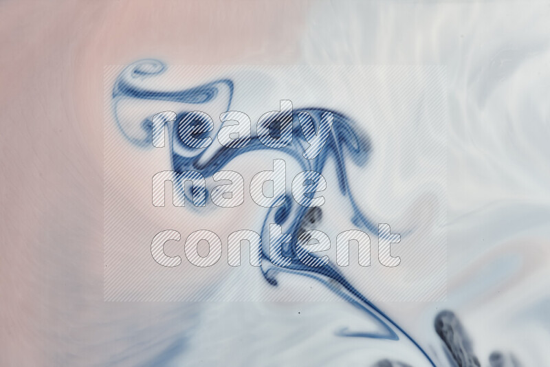 A close-up of abstract swirling patterns in blue, red and white