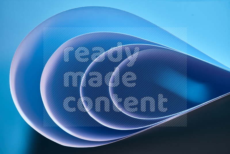 An abstract art of paper folded into smooth curves in blue gradients