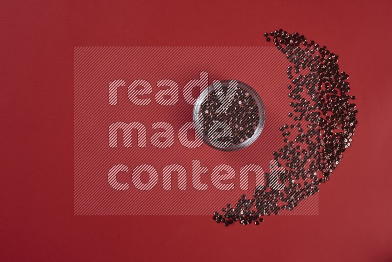 A red collection of sewing and tailoring tools arranged on a red background