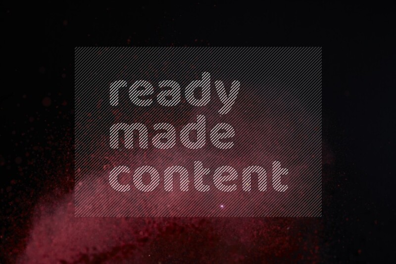Red powder explosion on black background