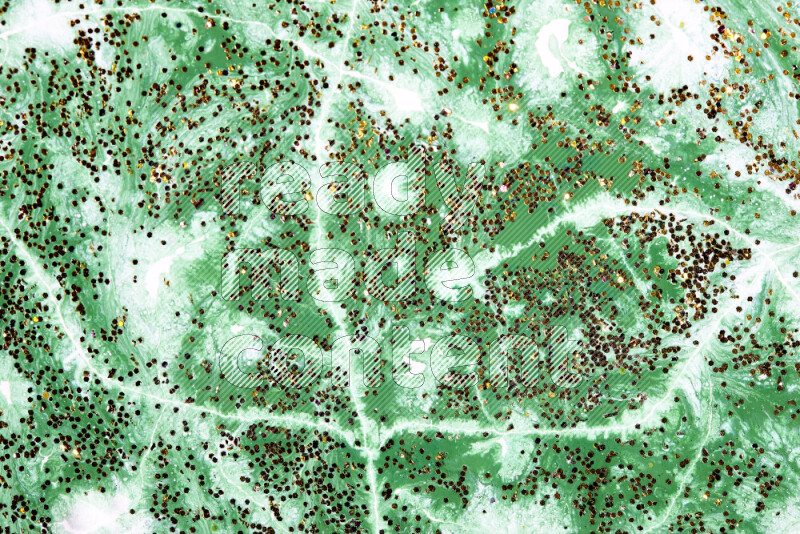 Abstract colorful background with mixed of green and white paint colors with scattered gold glitter