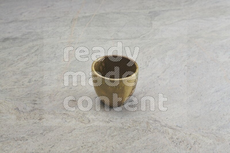 A multicolored pottery bowl on grey marble background