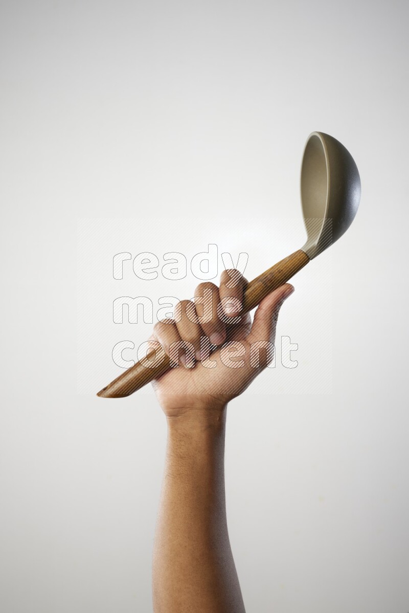 Male Hand Holding ladle on white background