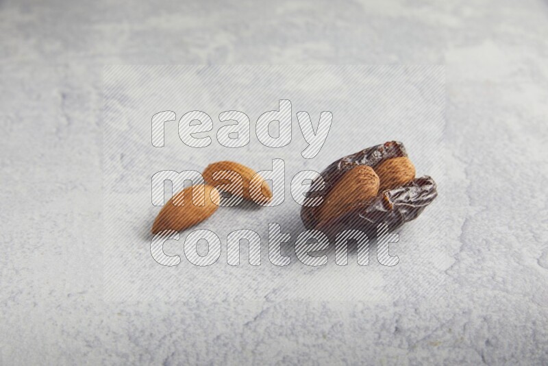 almond stuffed madjoul date on a light grey background