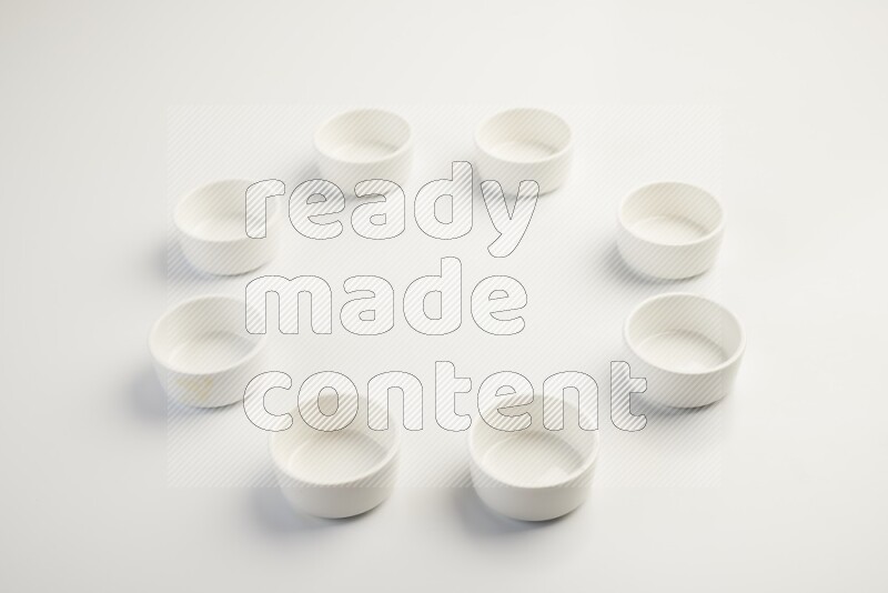 white ceramic round sauce dish on white countertop