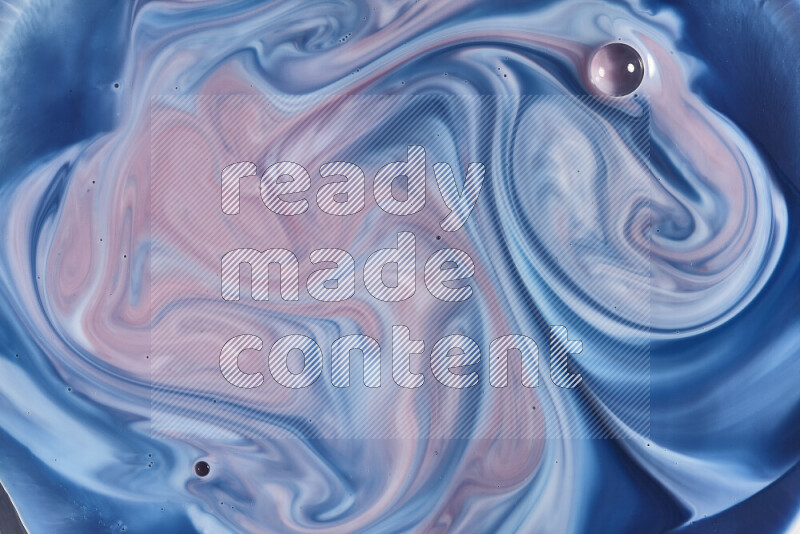 A close-up of abstract swirling patterns in blue, red and white