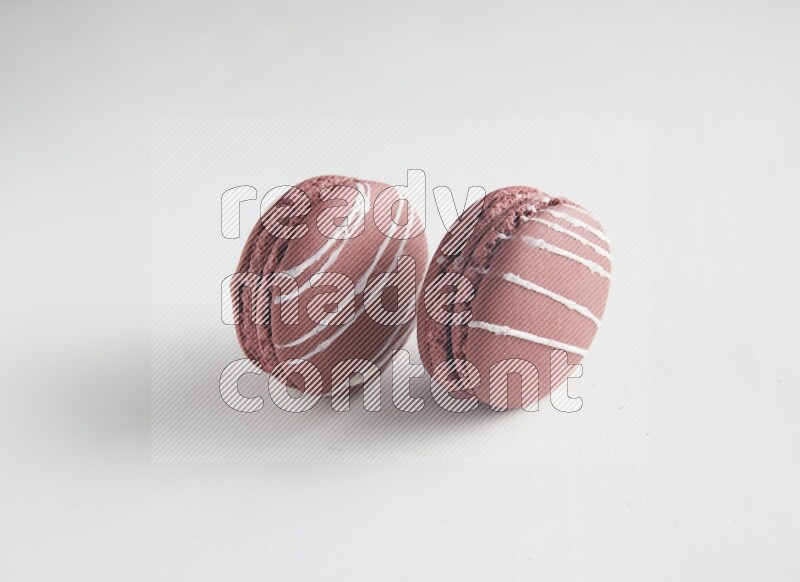 45º Shot of two Red Poppy Flower macarons on white background