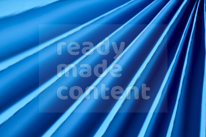 An image presenting an abstract paper pattern of lines in blue tones