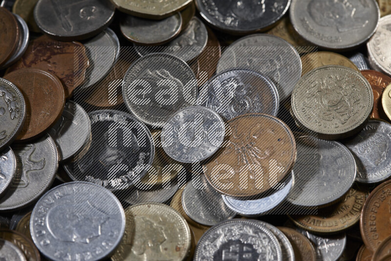A close-ups of random old coins on black background