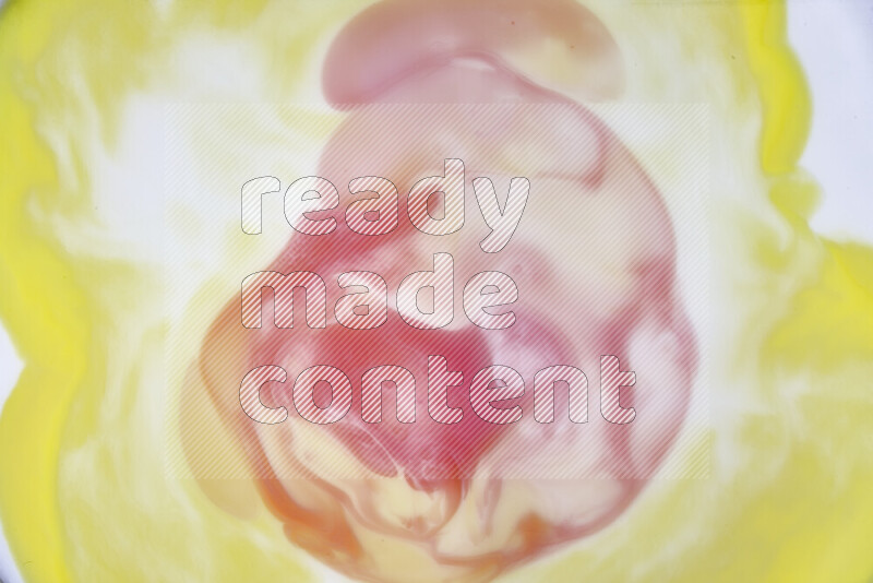 A close-up of abstract swirling patterns in yellow, red and white