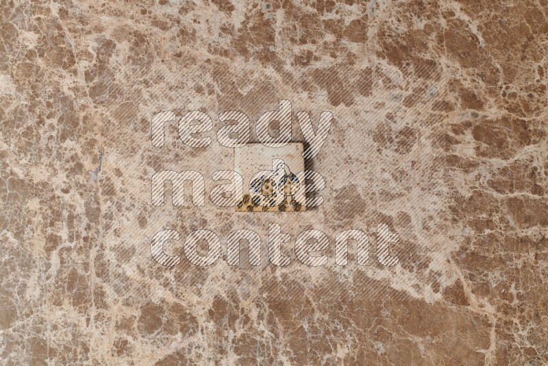 A decorative coaster on beige marble background