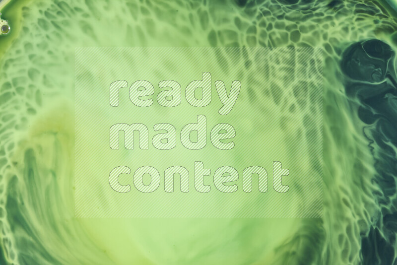 A close-up of abstract swirling patterns in green gradients