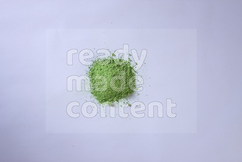 Green powder on white background