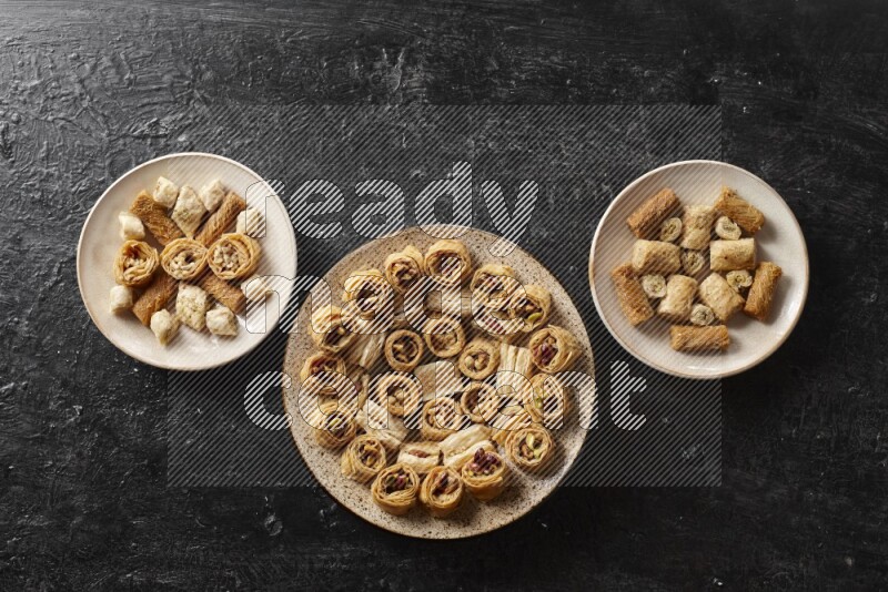Oriental sweets in pottery plates in a dark setup