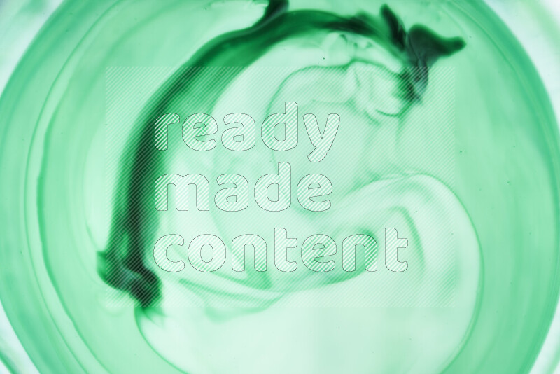 A close-up of abstract swirling patterns in green gradients