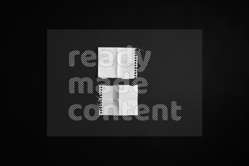 Ripped notebook sheet on black background