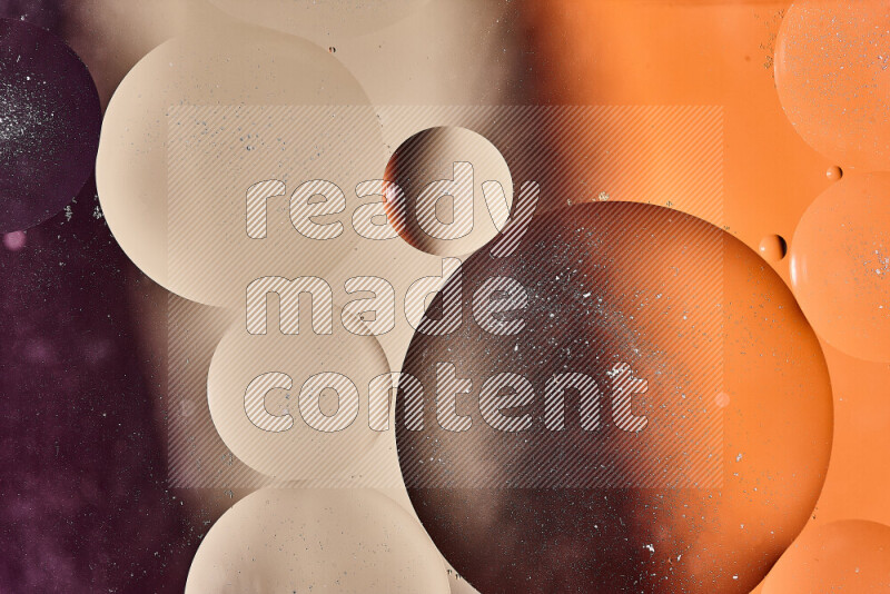 Close-ups of abstract oil bubbles on water surface in shades of brown, orange and purple
