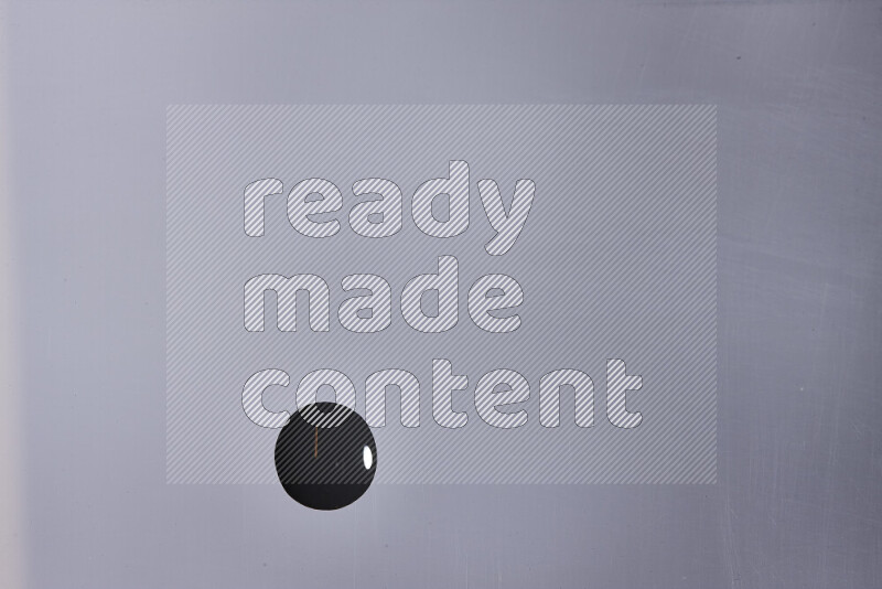 Close-ups of abstract black paint droplets on the surface