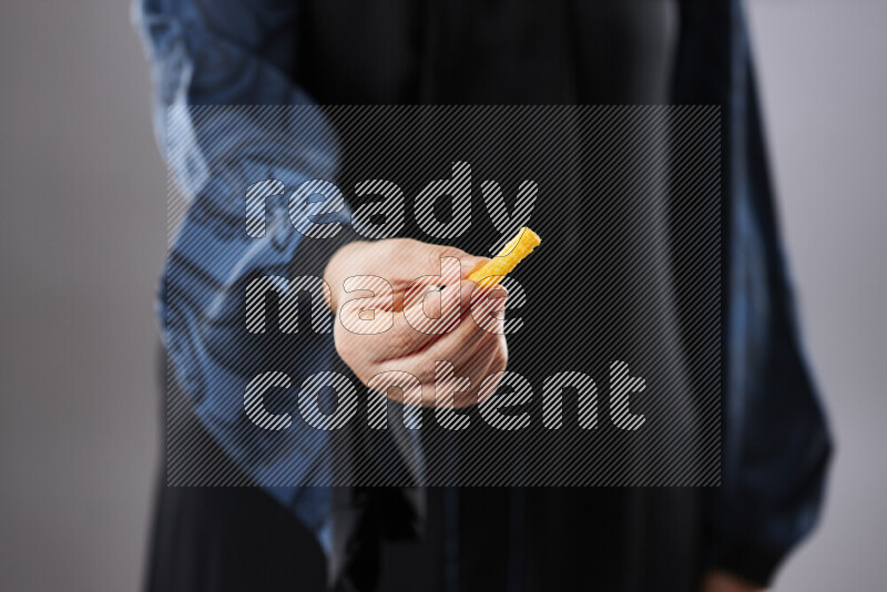 Woman in abaya holding different kinds of snacks in different positions