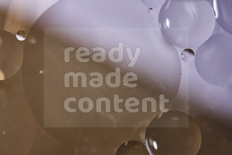 Close-ups of abstract oil bubbles on water surface in shades of white and brown