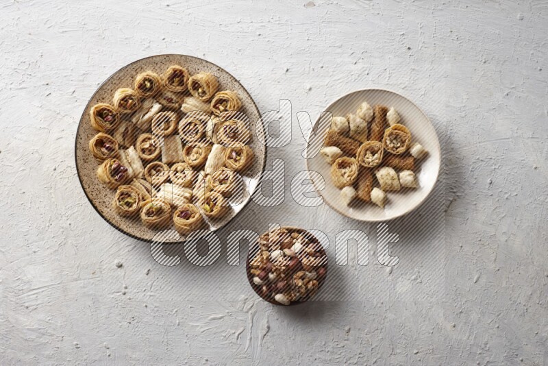 Oriental sweets in pottery plates with nuts in a light setup