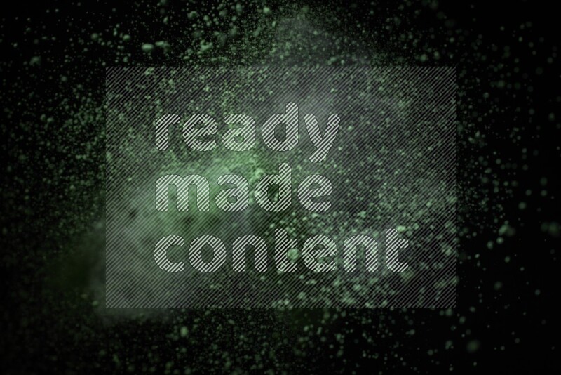 Green powder explosion on black background