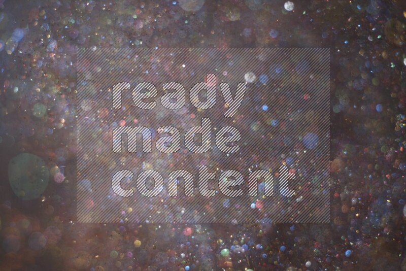 Multicolored glitter powder isolated on black background