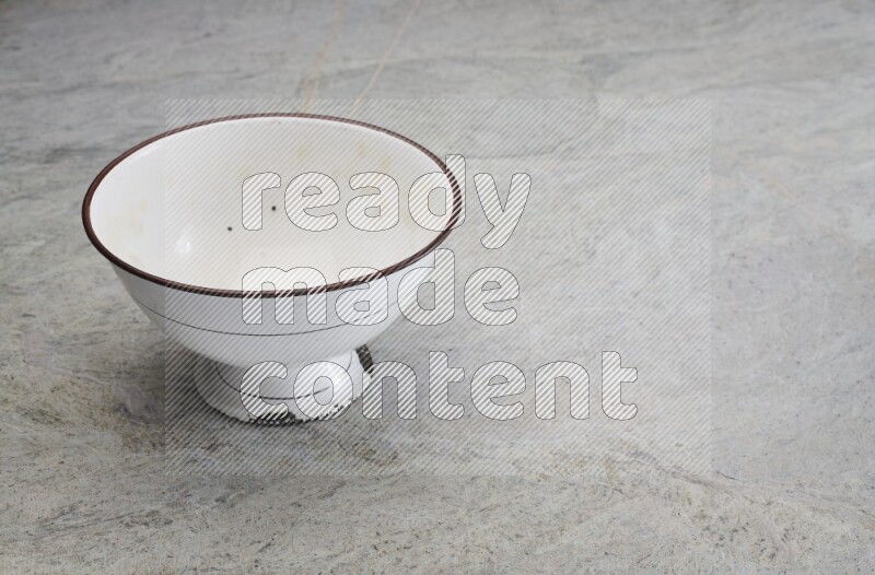 A vintage metal pot on grey marble background