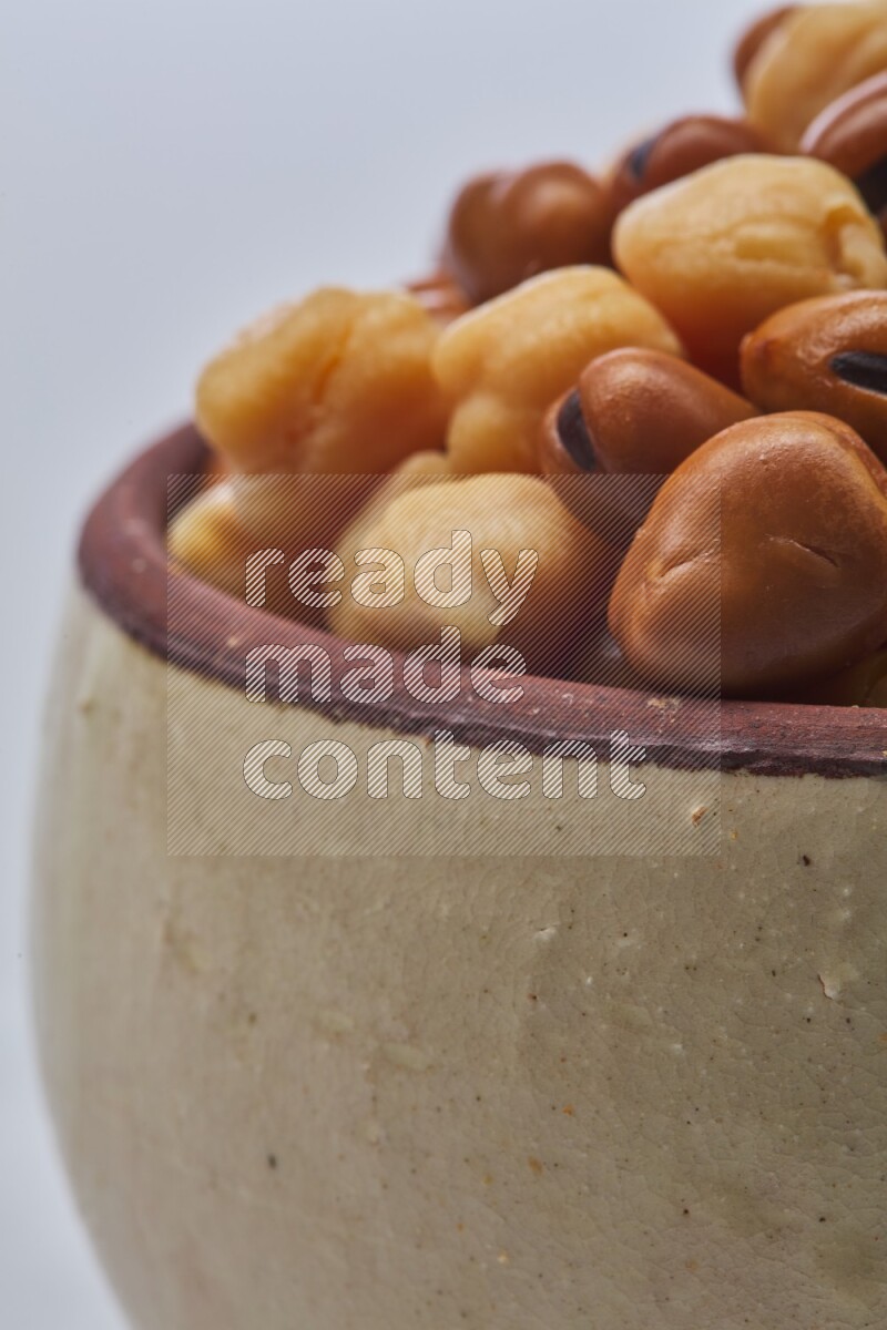 Close up shot of cooked fava beans (foul) & chickpeas on white background