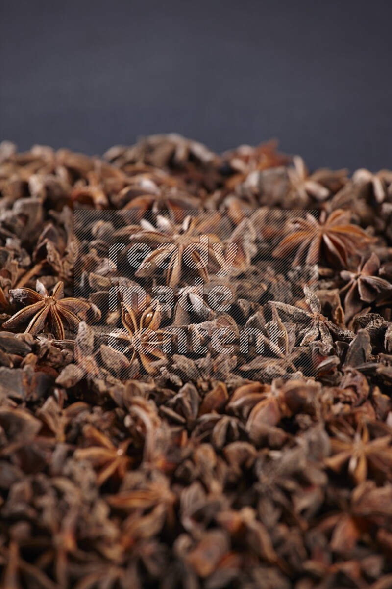 Star Anise herbs fill the frame on black flooring
