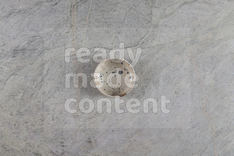 A multicolored pottery Bowl on grey marble background