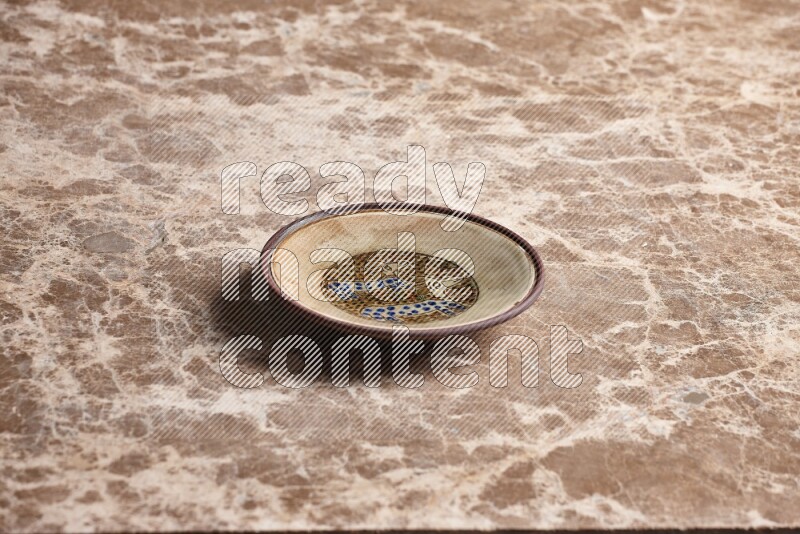 Decorative Pottery Plate on Beige Marble Flooring