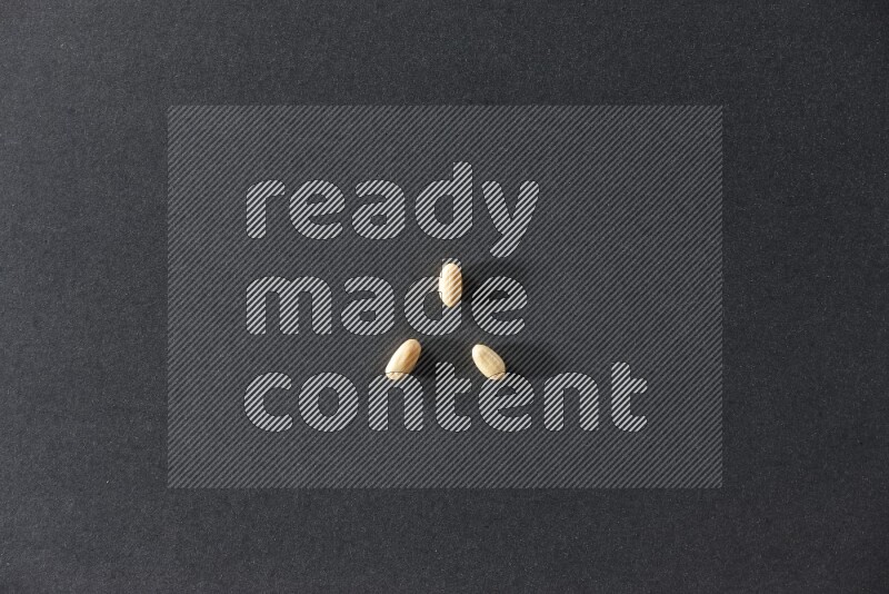 3 peeled peanuts on a black background in different angles