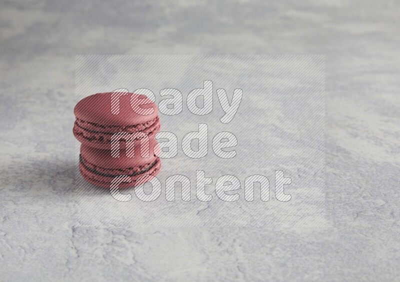 45º Shot of two Red Cherry macarons  on white  marble background
