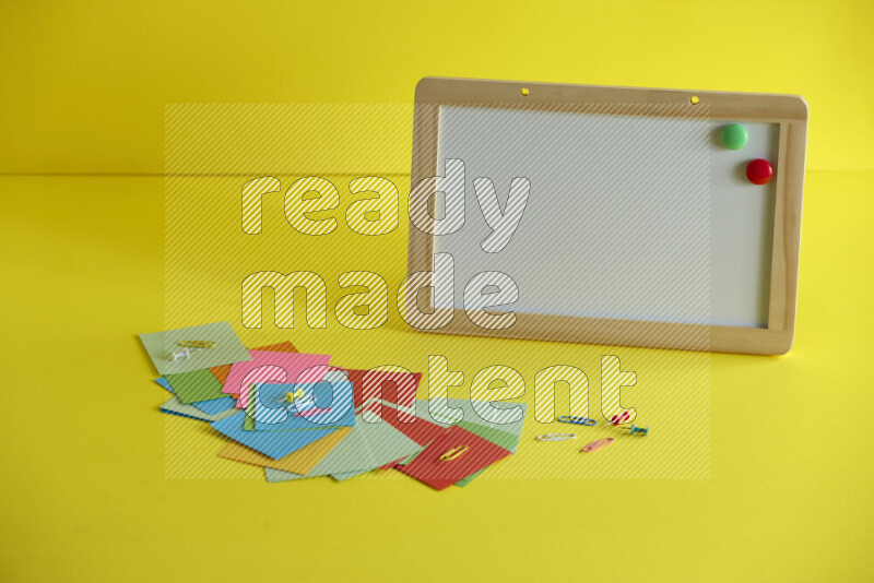 A whiteboard with different school supplies on yellow background