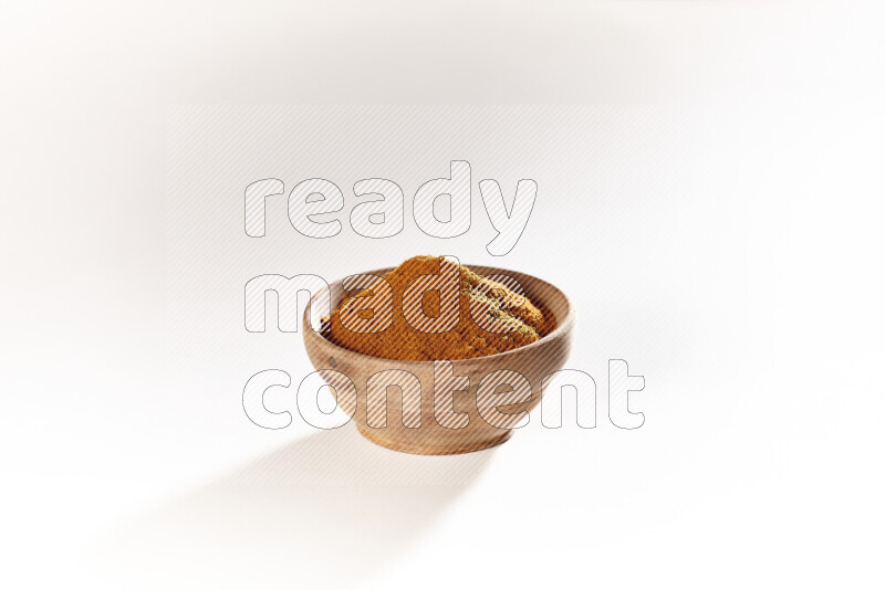 A wooden bowl full of ground paprika powder on white background