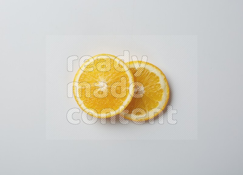 Two orange slices on white background
