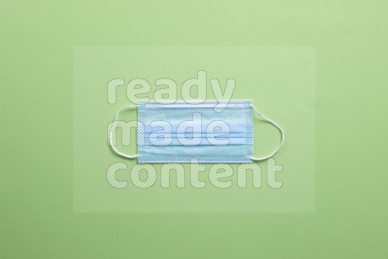 A face mask on green background