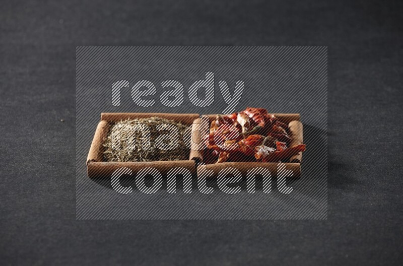 2 squares of cinnamon sticks full of chilis and cumin on black flooring