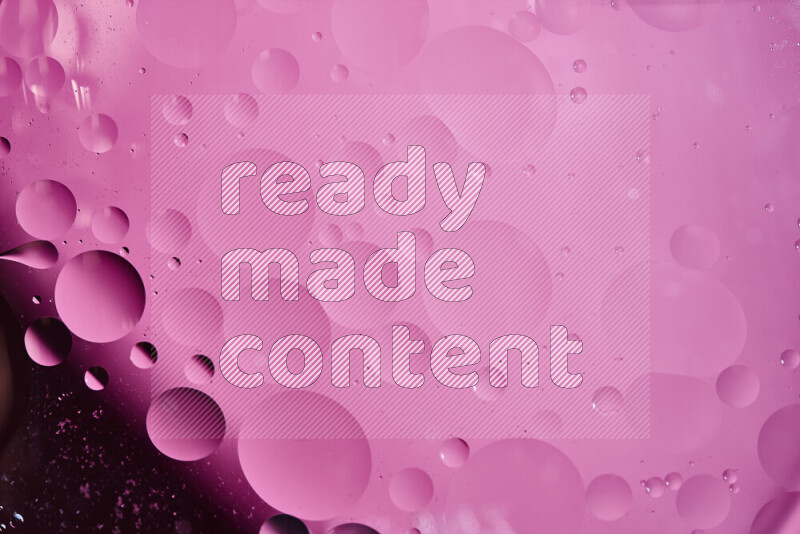 Close-ups of abstract oil bubbles on water surface in shades of purple and pink