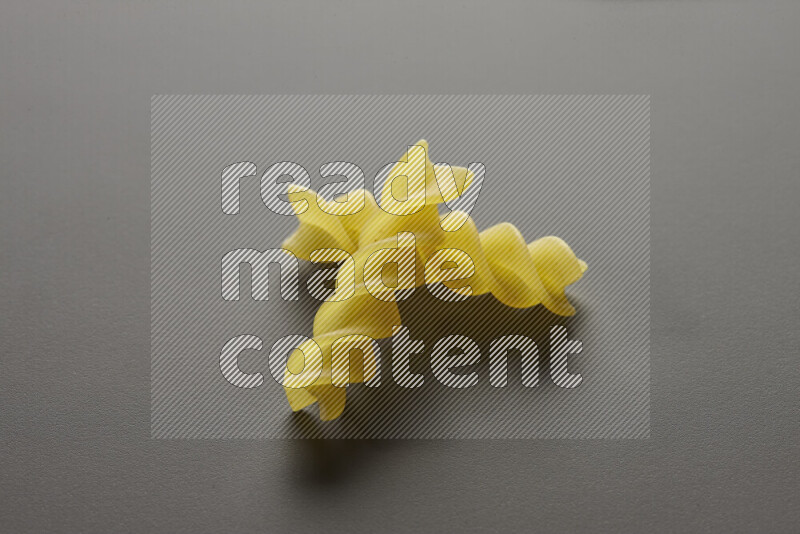 Fusilli pasta on grey background