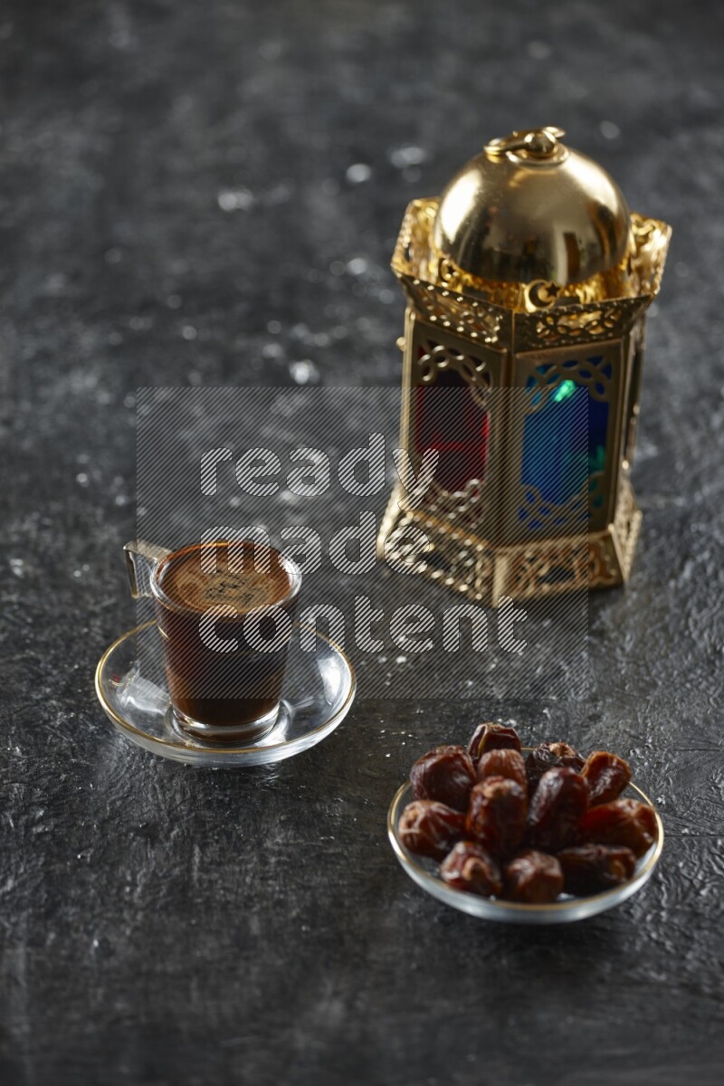 A golden lantern with different drinks, dates, nuts, prayer beads and quran on textured black background