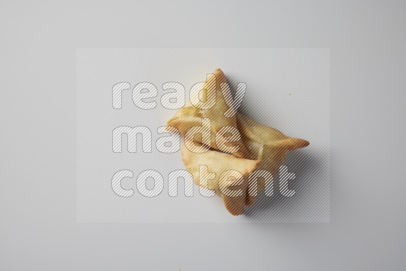 Three fried sambosa from a top angle on a white background